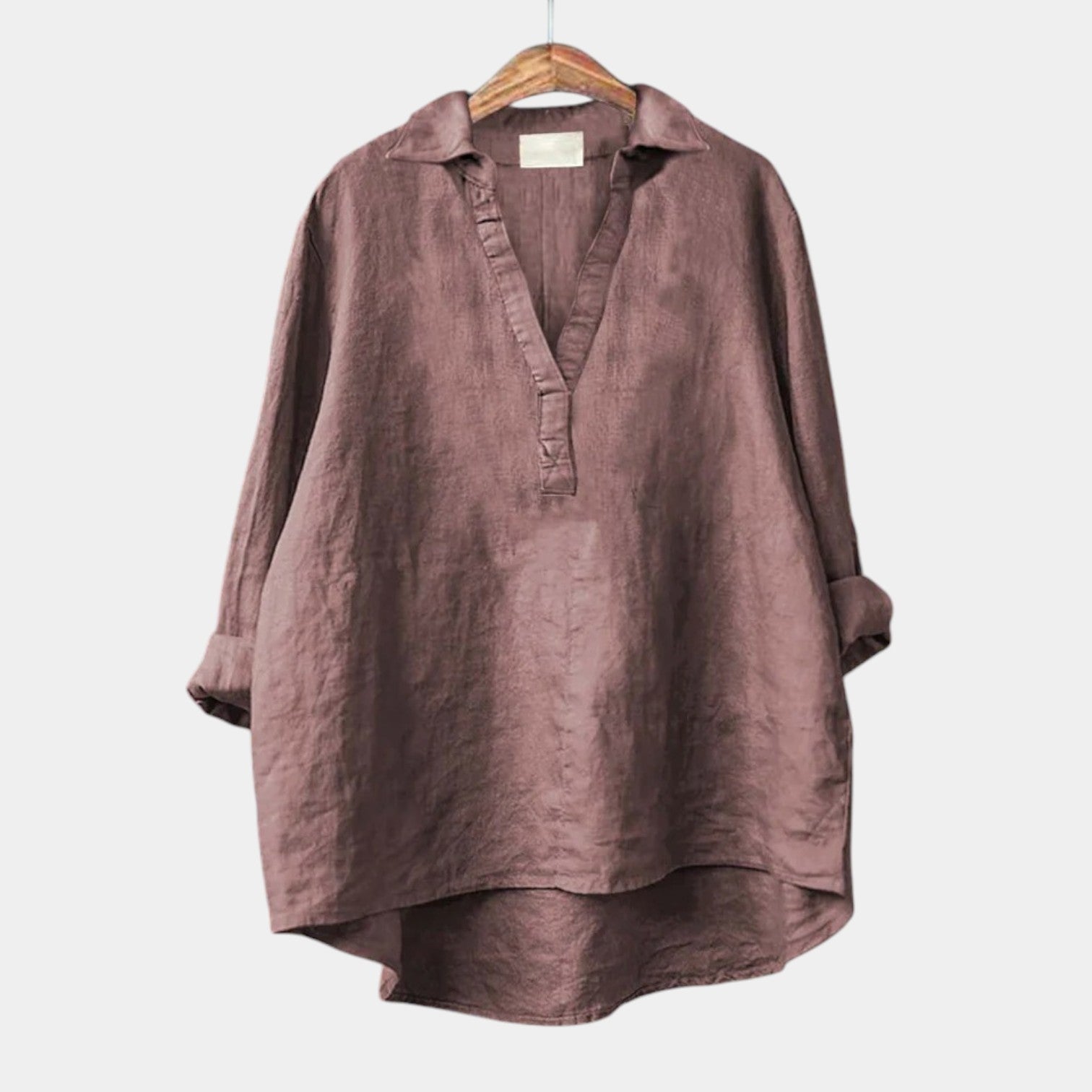 Woman wearing an elegant long-sleeve printed summer blouse styled with simple bottoms
