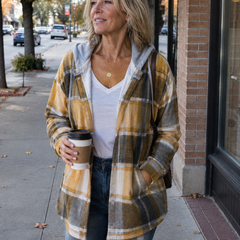 Woman wearing a cosy plaid hooded jacket with a soft, comfortable fit