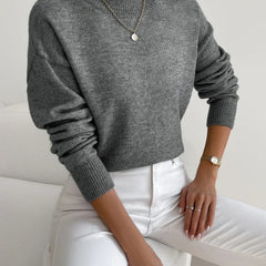 Women's crew neck sweater with ribbed cuffs and hemline in a solid shade