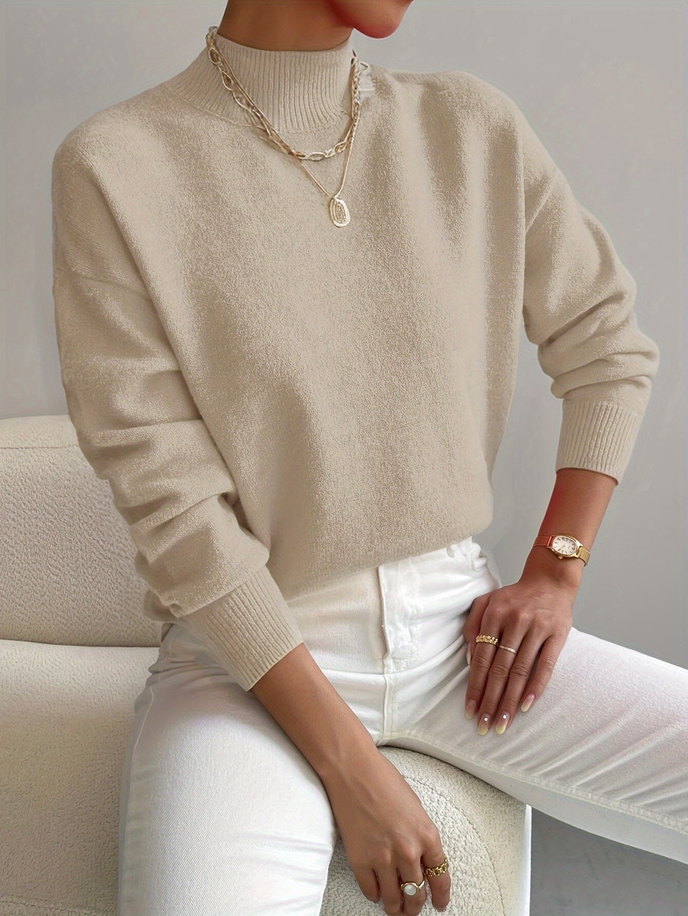 Women's crew neck sweater with ribbed cuffs and hemline in a solid shade