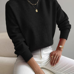 Women's crew neck sweater with ribbed cuffs and hemline in a solid shade