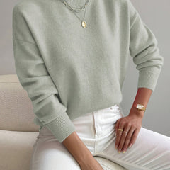 Women's crew neck sweater with ribbed cuffs and hemline in a solid shade