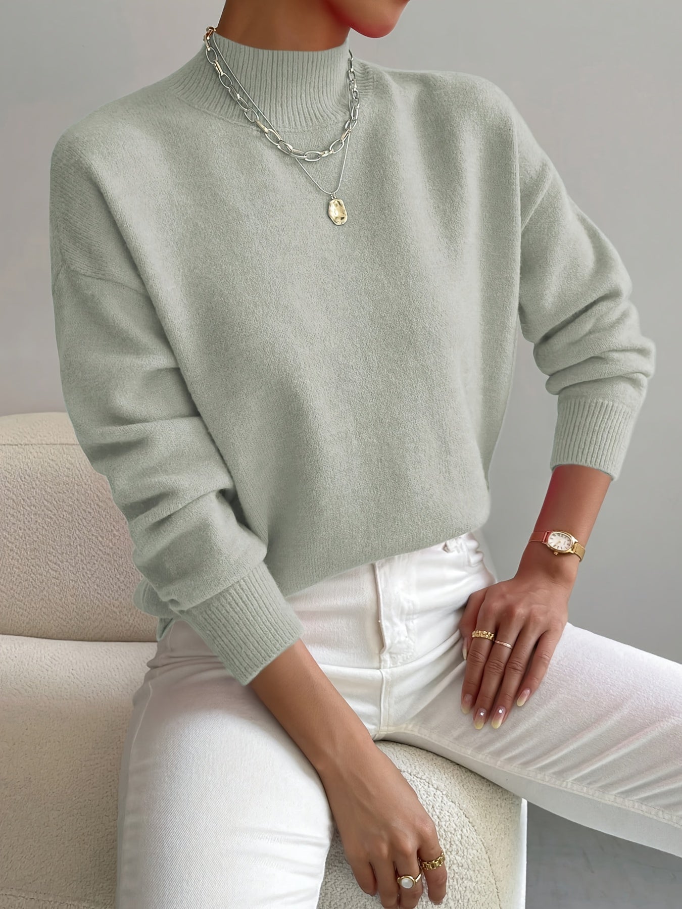 Women's crew neck sweater with ribbed cuffs and hemline in a solid shade