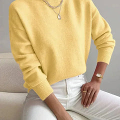 Women's crew neck sweater with ribbed cuffs and hemline in a solid shade