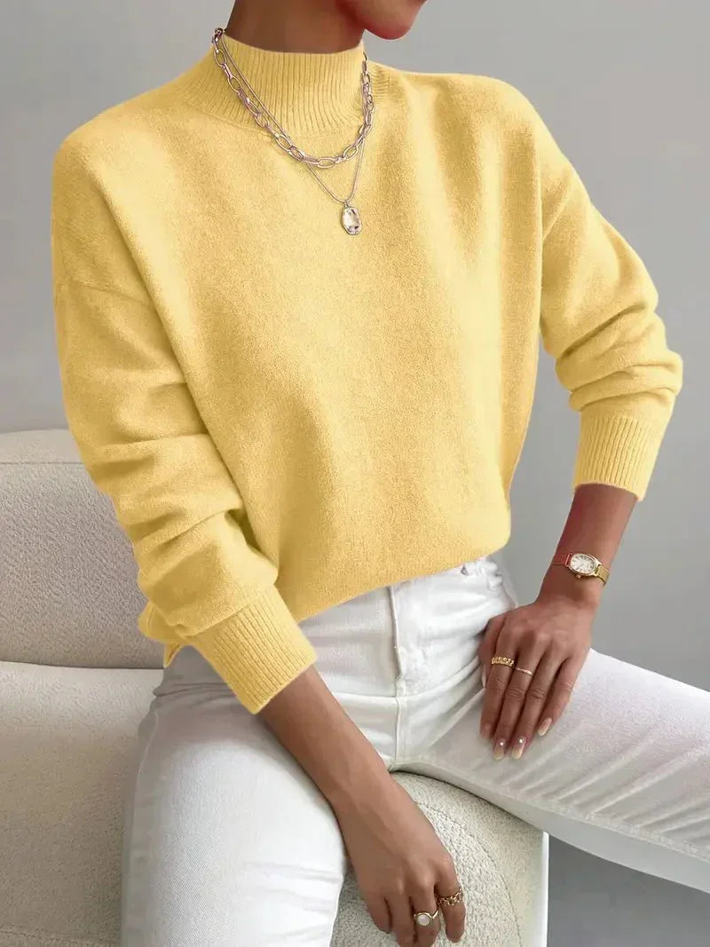 Women's crew neck sweater with ribbed cuffs and hemline in a solid shade