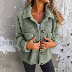Woman wearing a soft fleece button-front jacket with lapel collar and side pockets