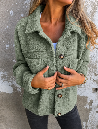 Woman wearing a soft fleece button-front jacket with lapel collar and side pockets