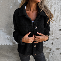 Woman wearing a soft fleece button-front jacket with lapel collar and side pockets