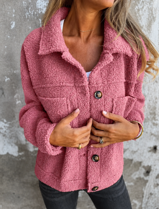 Woman wearing a soft fleece button-front jacket with lapel collar and side pockets