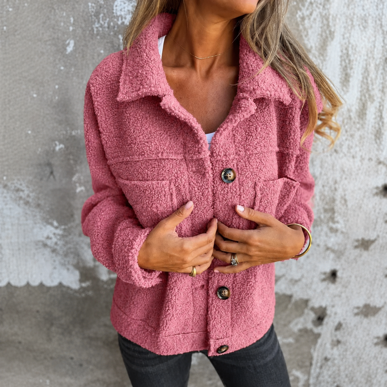 Woman wearing a soft fleece button-front jacket with lapel collar and side pockets