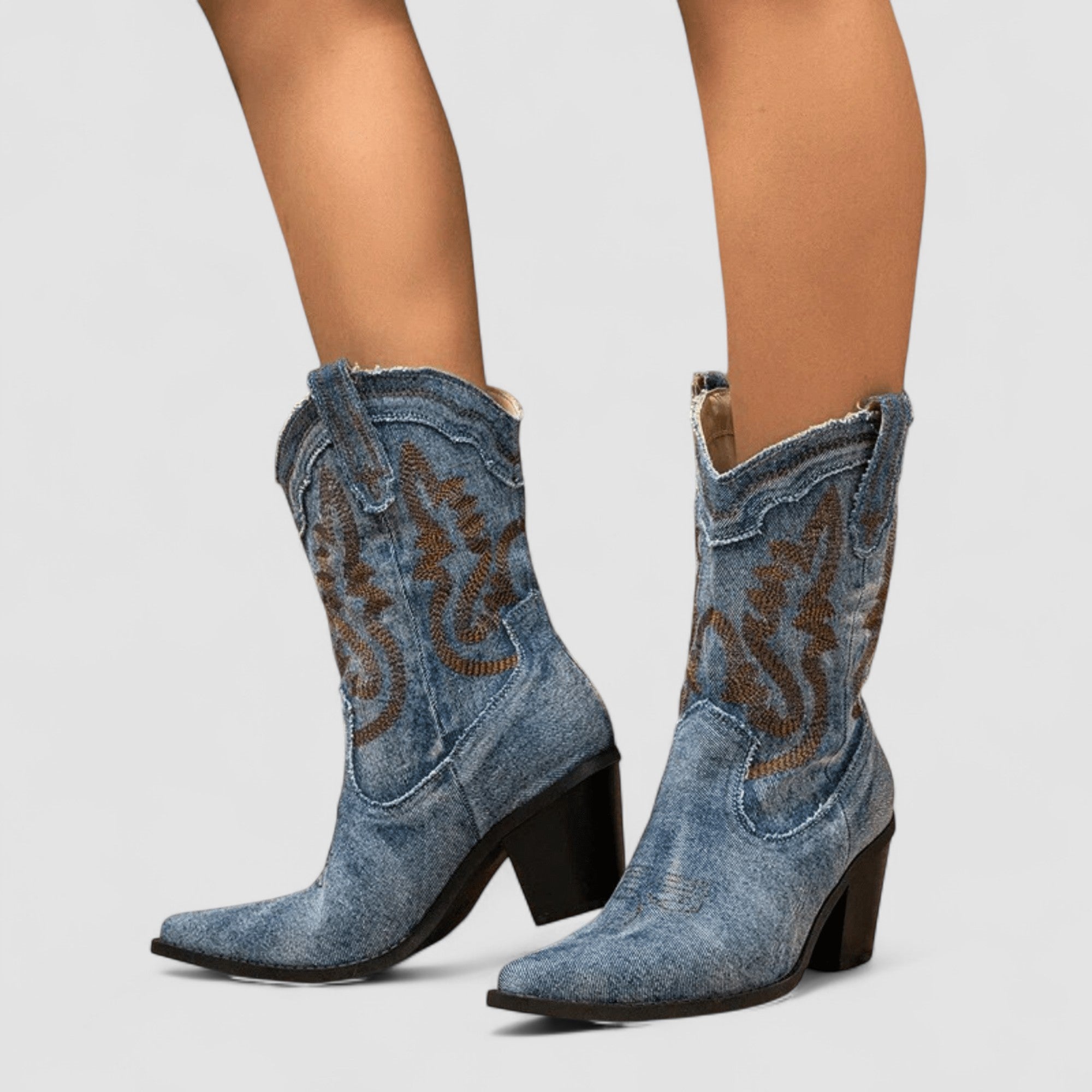 Embroidered western cowboy boots in faded blue with scrollwork shaft, pointed toe and block heel