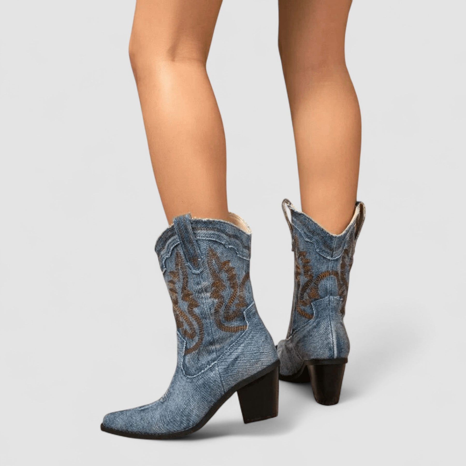 Embroidered western cowboy boots in faded blue with scrollwork shaft, pointed toe and block heel