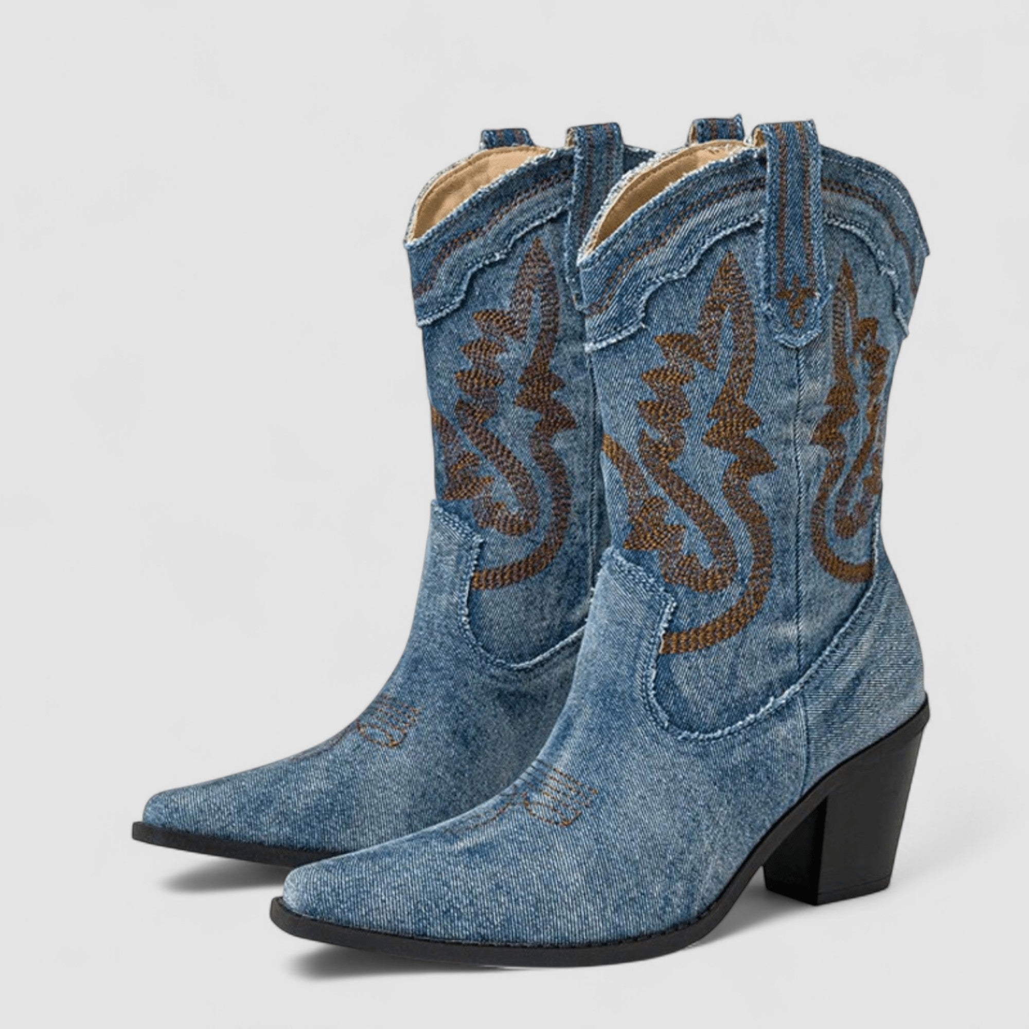 Embroidered western cowboy boots in faded blue with scrollwork shaft, pointed toe and block heel