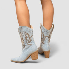 Embroidered western cowboy boots in faded blue with scrollwork shaft, pointed toe and block heel