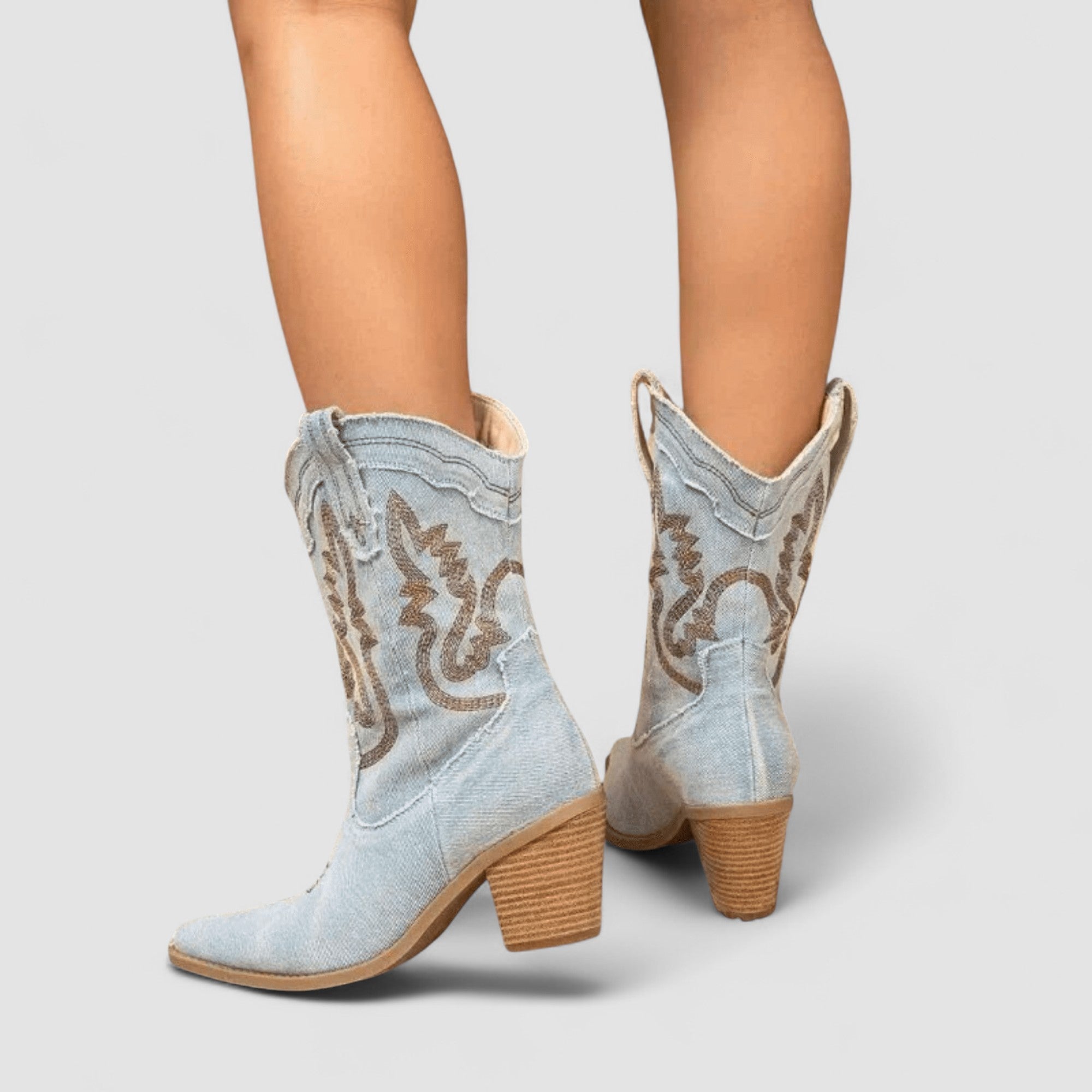Embroidered western cowboy boots in faded blue with scrollwork shaft, pointed toe and block heel