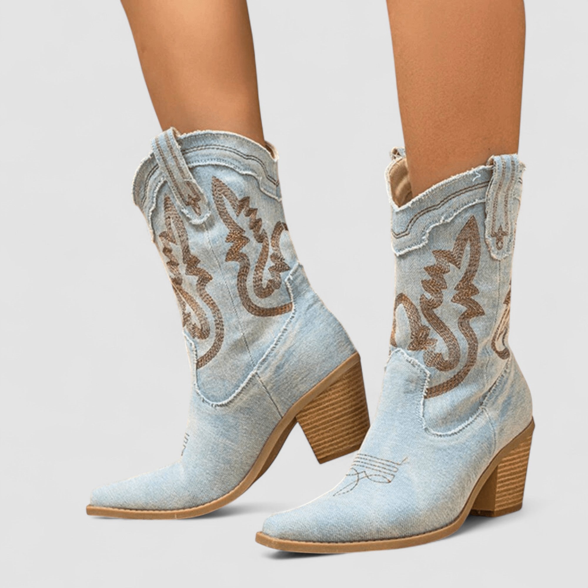 Embroidered western cowboy boots in faded blue with scrollwork shaft, pointed toe and block heel