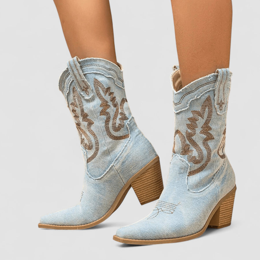 Embroidered western cowboy boots in faded blue with scrollwork shaft, pointed toe and block heel