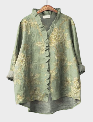 Green floral blouse with delicate ruffle trim and a relaxed, gently draped fit