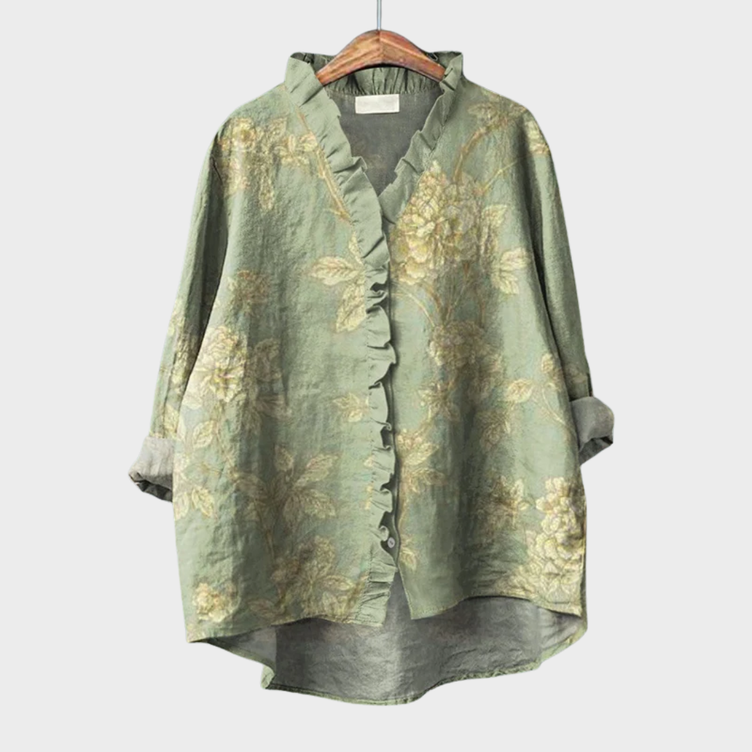Green floral blouse with delicate ruffle trim and a relaxed, gently draped fit