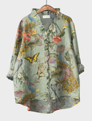 Green garden-print ruffle blouse with botanical and bird motif and a soft front ruffle