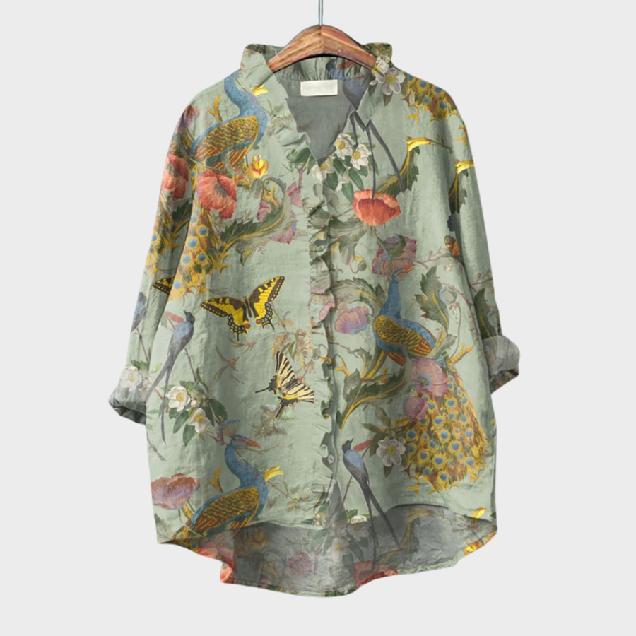 Green garden-print ruffle blouse with botanical and bird motif and a soft front ruffle