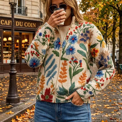 Cream floral zip cardigan with hand-drawn wildflowers, gold zipper and ribbed cuffs in a relaxed bomber fit