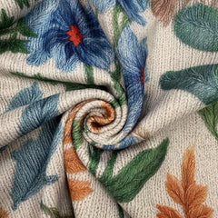 Cream floral zip cardigan with hand-drawn wildflowers, gold zipper and ribbed cuffs in a relaxed bomber fit