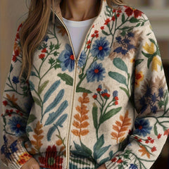 Cream floral zip cardigan with hand-drawn wildflowers, gold zipper and ribbed cuffs in a relaxed bomber fit