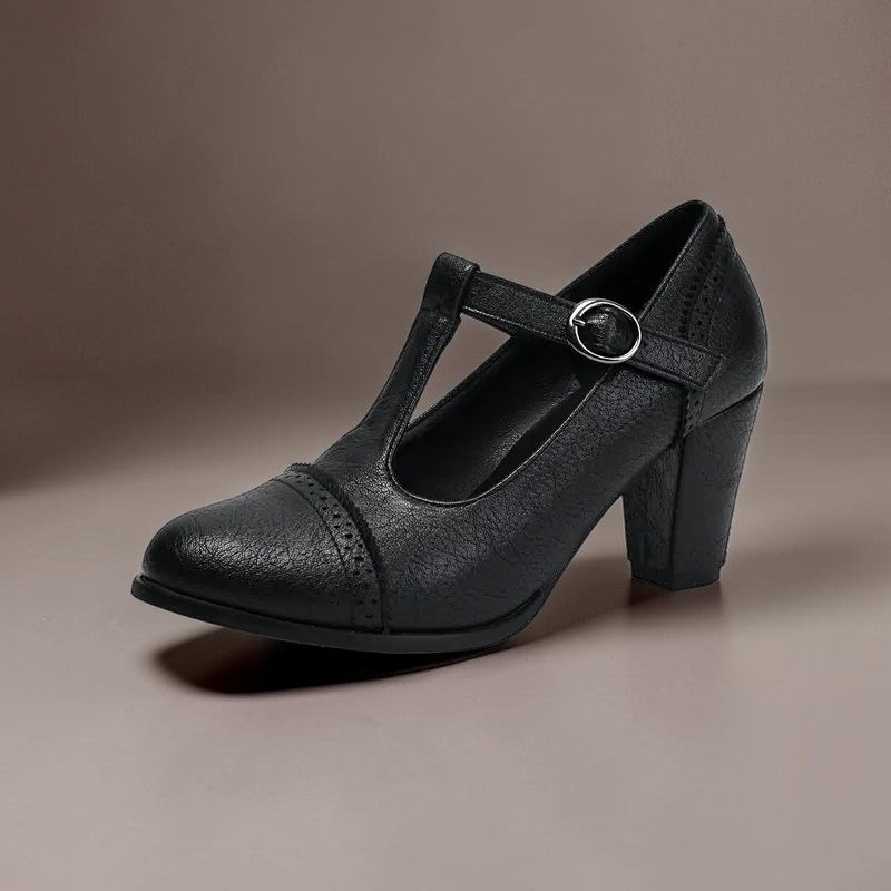 T-strap brogue heels with punched detailing on a steady block heel, shown in a neutral tone