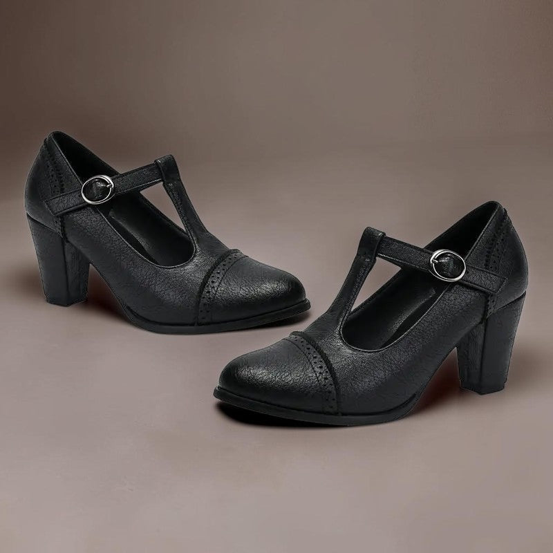 T-strap brogue heels with punched detailing on a steady block heel, shown in a neutral tone
