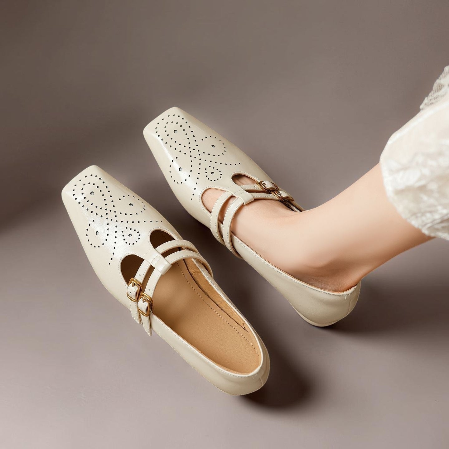 Brogued leather Mary Jane pump with dual buckled straps and a low block heel