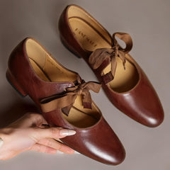 Leather bow Mary Jane flats with strap, shown in red, black and brown