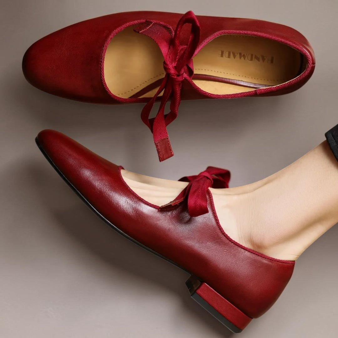 Leather bow Mary Jane flats with strap, shown in red, black and brown