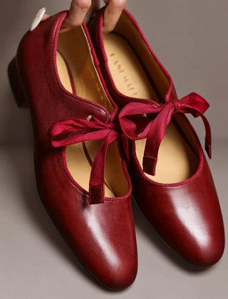 Leather bow Mary Jane flats with strap, shown in red, black and brown