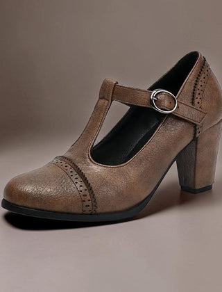 T-strap brogue heels with punched detailing on a steady block heel, shown in a neutral tone