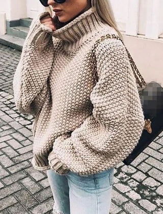 Woman wearing an oversized chunky knit turtleneck sweater with a relaxed fit and ribbed collar
