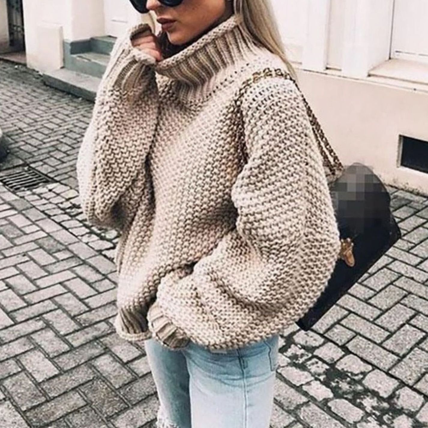 Woman wearing an oversized chunky knit turtleneck sweater with a relaxed fit and ribbed collar