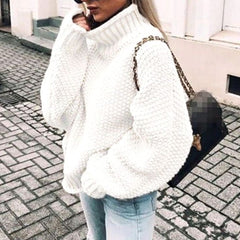 Woman wearing an oversized chunky knit turtleneck sweater with a relaxed fit and ribbed collar