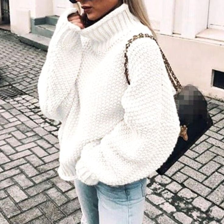 Woman wearing an oversized chunky knit turtleneck sweater with a relaxed fit and ribbed collar