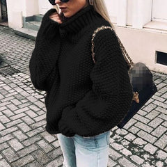 Woman wearing an oversized chunky knit turtleneck sweater with a relaxed fit and ribbed collar