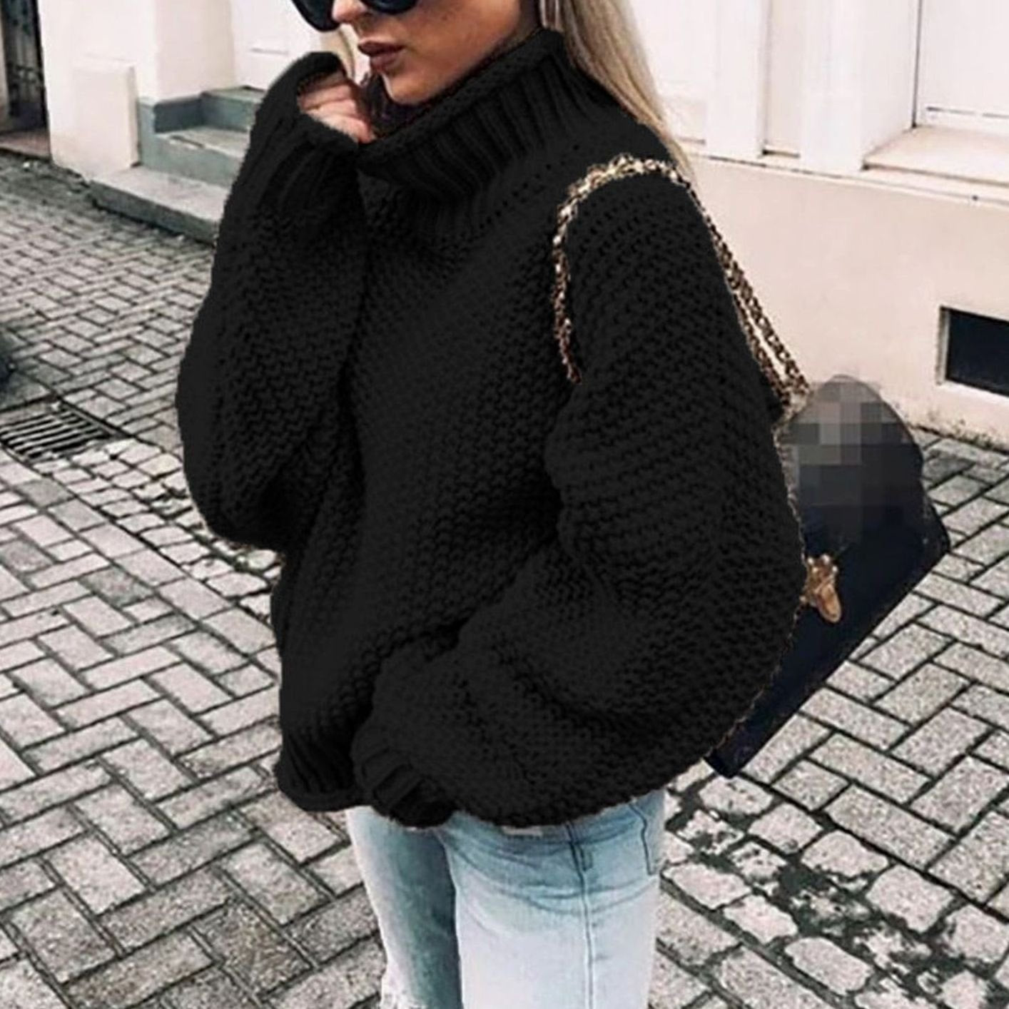 Woman wearing an oversized chunky knit turtleneck sweater with a relaxed fit and ribbed collar