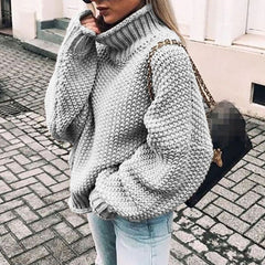Woman wearing an oversized chunky knit turtleneck sweater with a relaxed fit and ribbed collar
