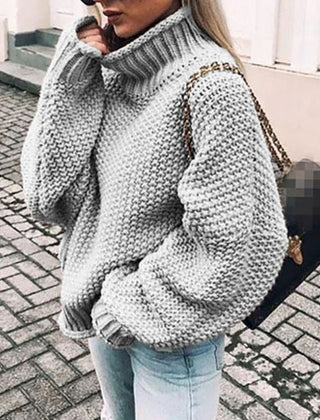 Woman wearing an oversized chunky knit turtleneck sweater with a relaxed fit and ribbed collar