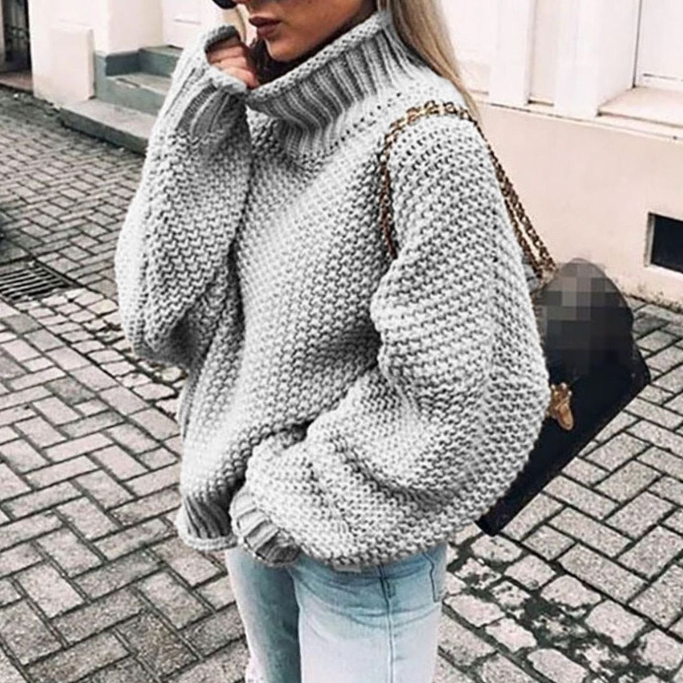 Woman wearing an oversized chunky knit turtleneck sweater with a relaxed fit and ribbed collar