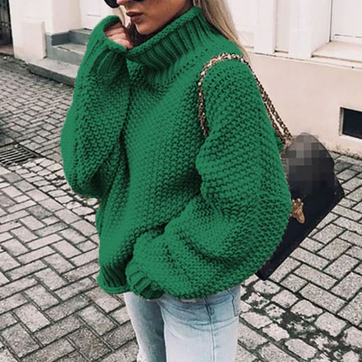 Woman wearing an oversized chunky knit turtleneck sweater with a relaxed fit and ribbed collar