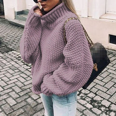 Woman wearing an oversized chunky knit turtleneck sweater with a relaxed fit and ribbed collar