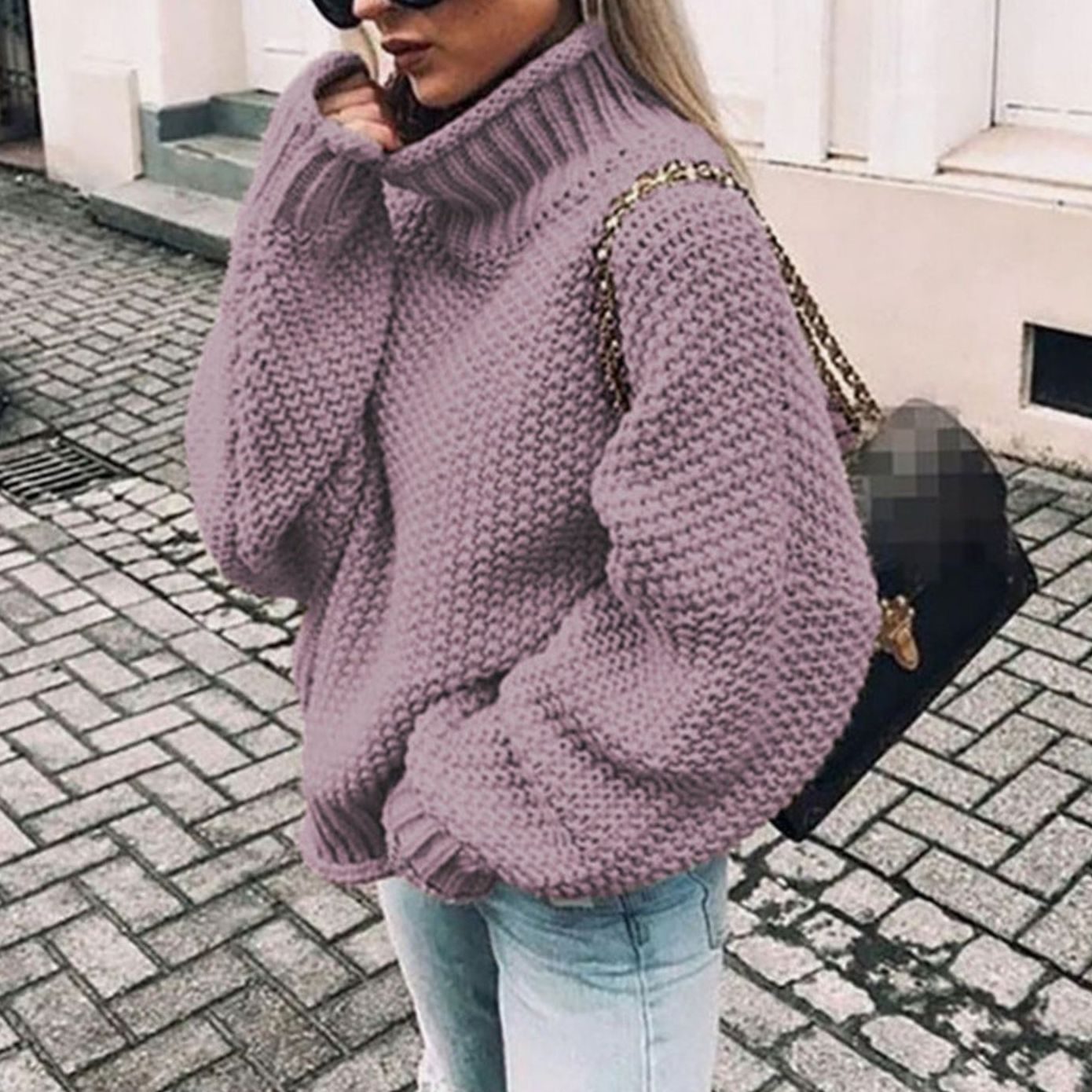 Woman wearing an oversized chunky knit turtleneck sweater with a relaxed fit and ribbed collar