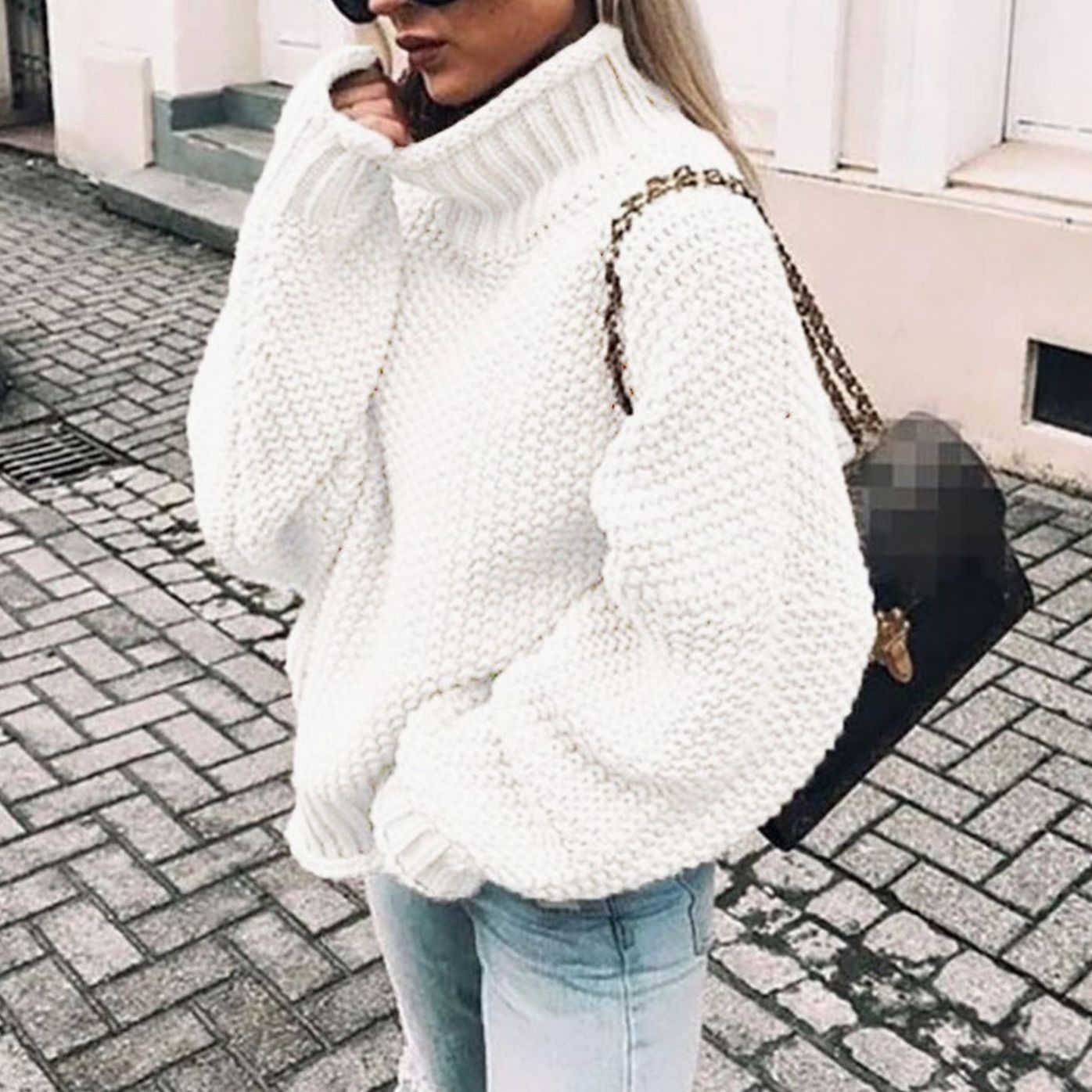 Woman wearing an oversized chunky knit turtleneck sweater with a relaxed fit and ribbed collar