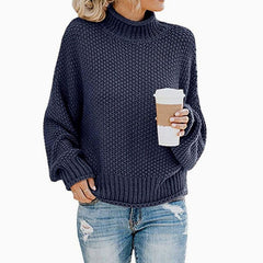 Woman wearing an oversized chunky knit turtleneck sweater with a relaxed fit and ribbed collar