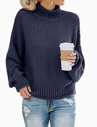 Woman wearing an oversized chunky knit turtleneck sweater with a relaxed fit and ribbed collar